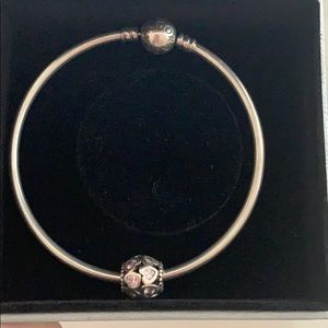 Pandora bracelet with pink hearts charm.